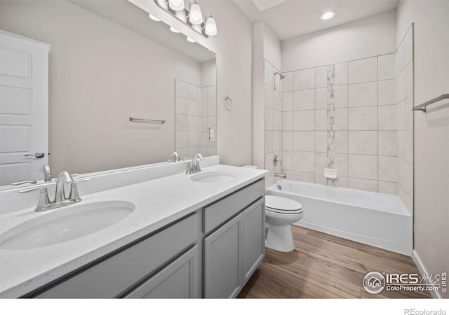 196 Bird Way, Lochbuie, CO 80603 - bathroom featuring wood finished floors, double vanity, toilet, bathtub / shower combination, and recessed lighting