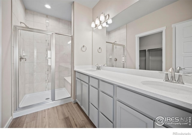 196 Bird Way, Lochbuie, CO 80603 - full bath with a shower stall, double vanity, wood finished floors, and a walk in closet