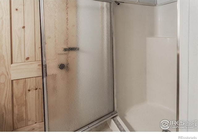 full bath with a shower stall