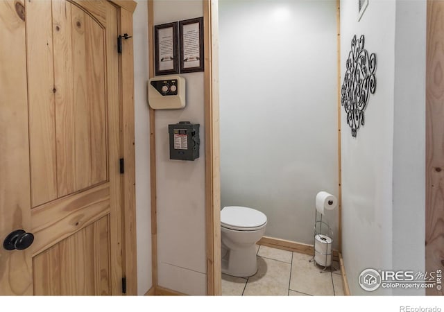 bathroom with tile patterned flooring and toilet