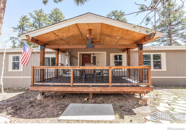 exterior space featuring a ceiling fan and a deck