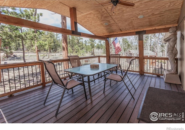 wooden deck featuring a ceiling fan and outdoor dining space