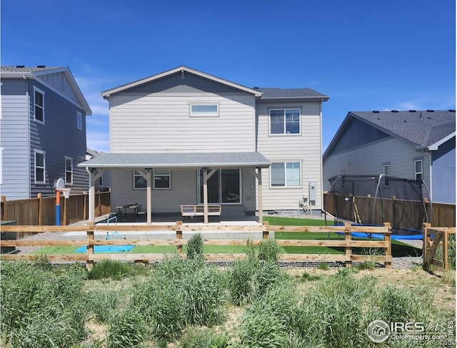1312 Loraine Cir S, Lafayette, CO 80026 - rear view of property with a trampoline and fence