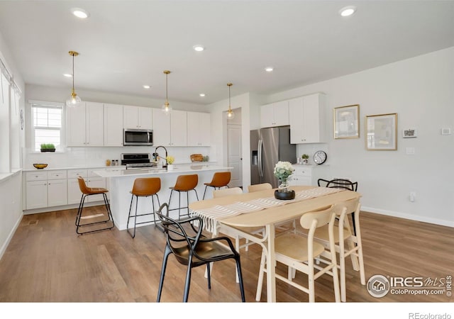 1312 Loraine Cir S, Lafayette, CO 80026 - dining room with recessed lighting, baseboards, and light wood finished floors