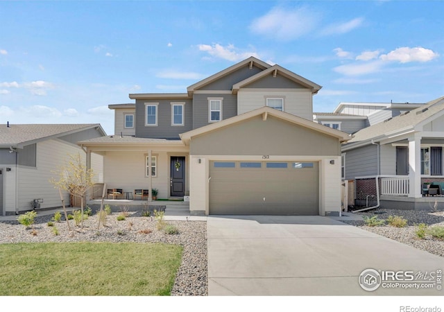 1312 Loraine Cir S, Lafayette, CO 80026 - view of front facade with covered porch, an attached garage, and concrete driveway