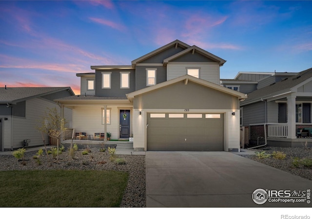 1312 Loraine Cir S, Lafayette, CO 80026 - view of front facade featuring covered porch, concrete driveway, and a garage