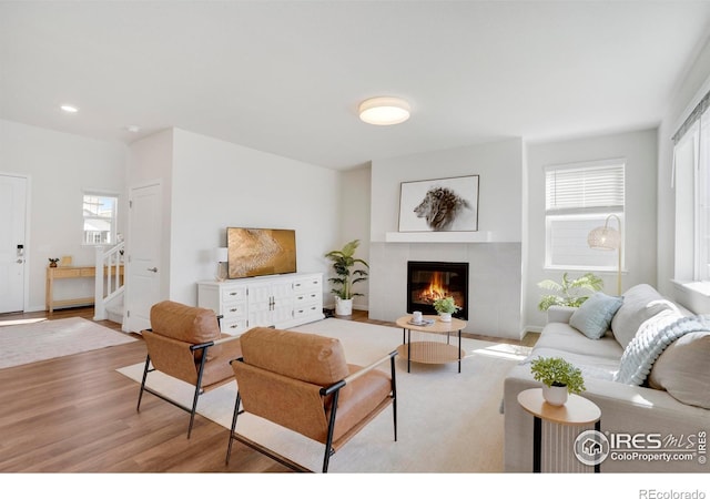 1312 Loraine Cir S, Lafayette, CO 80026 - living room featuring light wood-style floors, a fireplace, recessed lighting, and a wealth of natural light