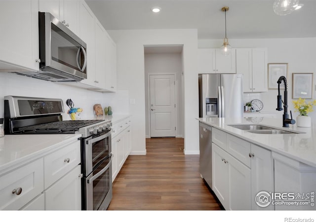 1312 Loraine Cir S, Lafayette, CO 80026 - kitchen with a sink, white cabinetry, backsplash, and stainless steel appliances