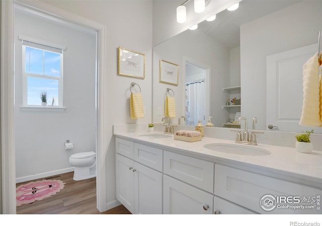 1312 Loraine Cir S, Lafayette, CO 80026 - full bath with a sink, double vanity, toilet, and wood finished floors