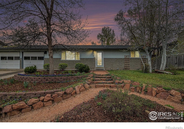 single story home featuring fence, brick siding, an attached garage, and driveway