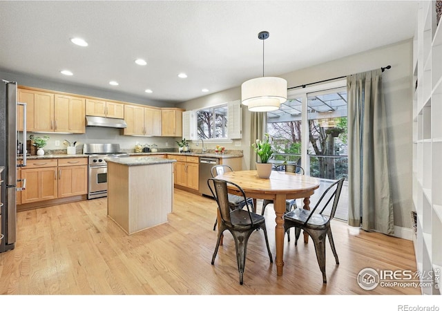 kitchen with light brown cabinets, stainless steel appliances, recessed lighting, light wood-type flooring, and under cabinet range hood