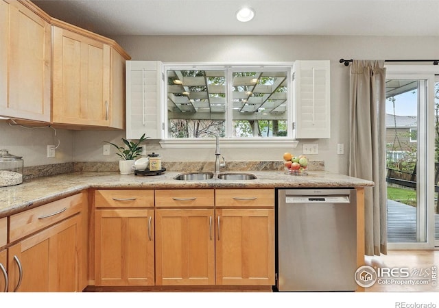 kitchen with light brown cabinetry, light stone counters, a sink, recessed lighting, and stainless steel dishwasher