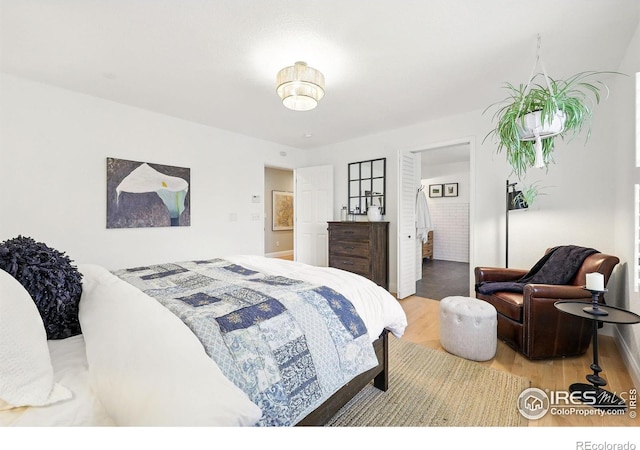 bedroom with baseboards and wood finished floors