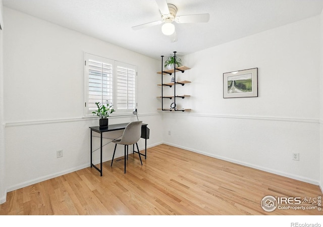 office area featuring baseboards, a ceiling fan, and wood finished floors