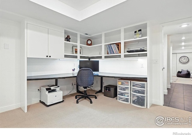 carpeted office space featuring visible vents and built in study area