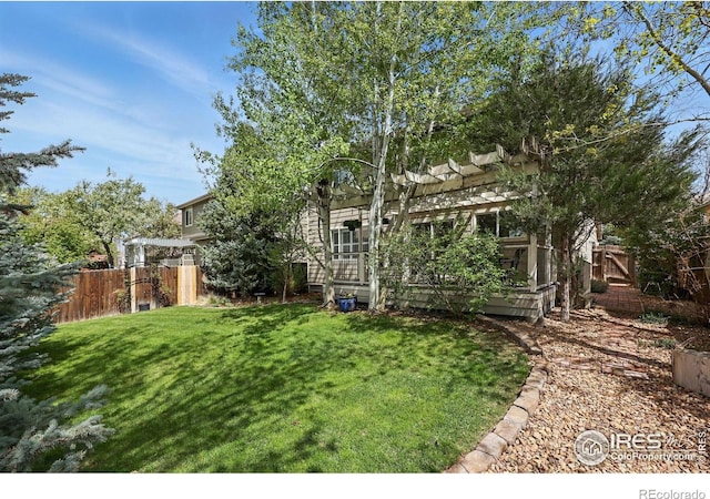 view of yard featuring a pergola and fence