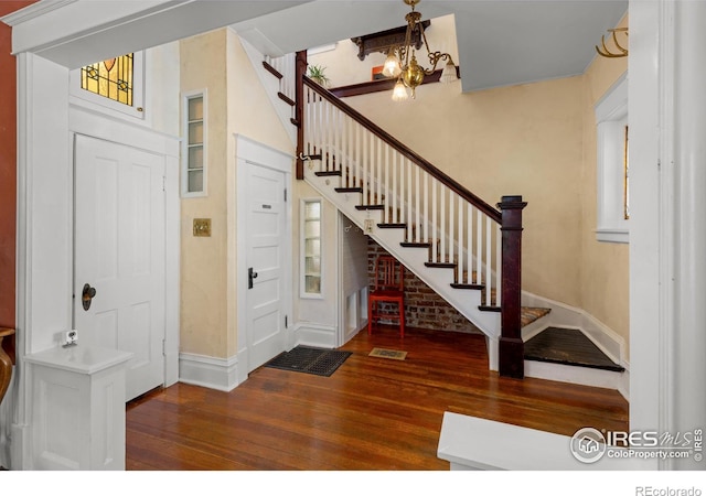 838 University Ave, Boulder, CO 80302 - foyer entrance with stairs, baseboards, an inviting chandelier, and hardwood / wood-style flooring