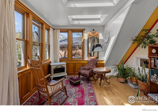 838 University Ave, Boulder, CO 80302 - sitting room featuring a skylight, heating unit, a wood stove, and wood finished floors