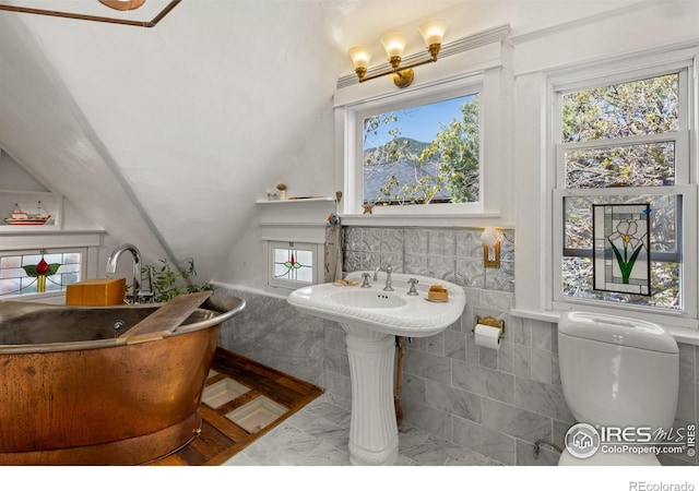 838 University Ave, Boulder, CO 80302 - full bath with a freestanding tub, tile walls, tile patterned floors, and vaulted ceiling