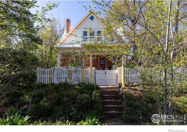 838 University Ave, Boulder, CO 80302 - victorian house with a fenced front yard, a gate, and a chimney