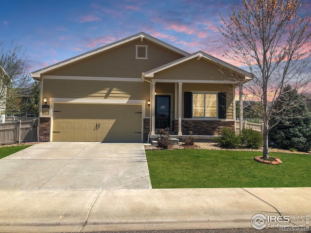 craftsman inspired home with fence, an attached garage, stone siding, concrete driveway, and a lawn