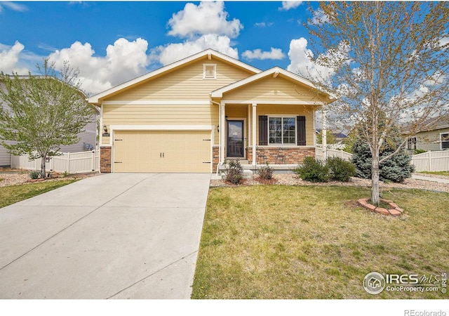 craftsman-style home featuring driveway, a front yard, a garage, brick siding, and fence