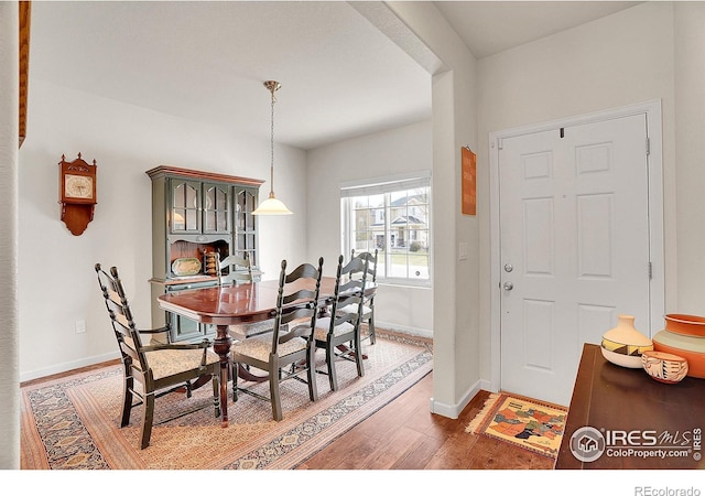 dining space with light wood-style floors and baseboards