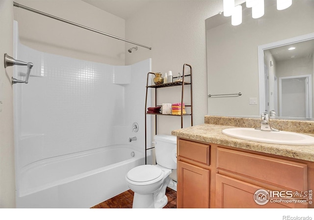 bathroom with vanity, toilet, wood finished floors, and  shower combination