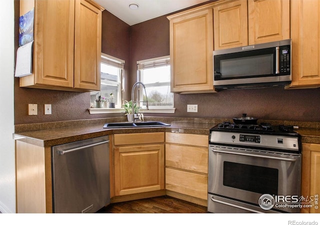 kitchen featuring a sink, light brown cabinets, tile counters, stainless steel appliances, and dark wood-type flooring