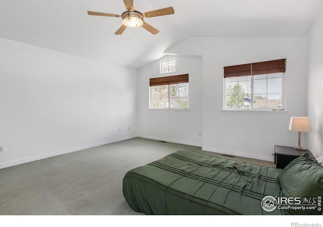carpeted bedroom with baseboards, ceiling fan, and vaulted ceiling