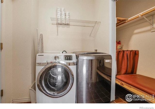 laundry room with washer and dryer, laundry area, and tile patterned flooring