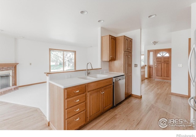 1609 Sherman Way, Longmont, CO 80501 - kitchen featuring a sink, plenty of natural light, stainless steel dishwasher, and light wood-type flooring