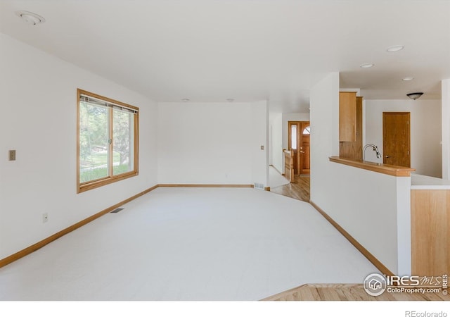 1609 Sherman Way, Longmont, CO 80501 - unfurnished room with visible vents, a sink, baseboards, light carpet, and recessed lighting