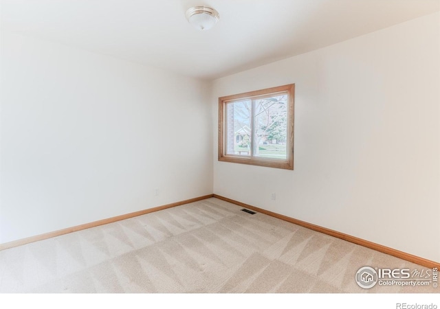 1609 Sherman Way, Longmont, CO 80501 - empty room featuring visible vents, baseboards, and light carpet