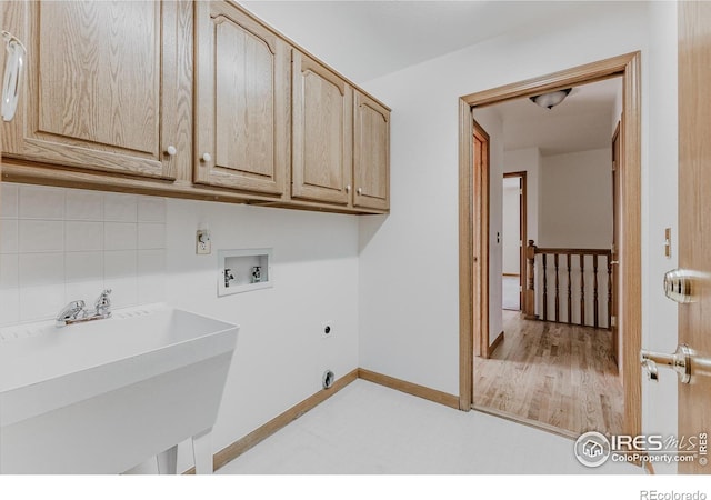1609 Sherman Way, Longmont, CO 80501 - laundry area with cabinet space, a sink, hookup for a washing machine, electric dryer hookup, and baseboards