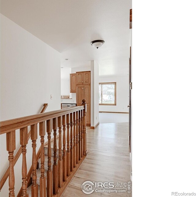 1609 Sherman Way, Longmont, CO 80501 - hall with baseboards, light wood finished floors, and an upstairs landing