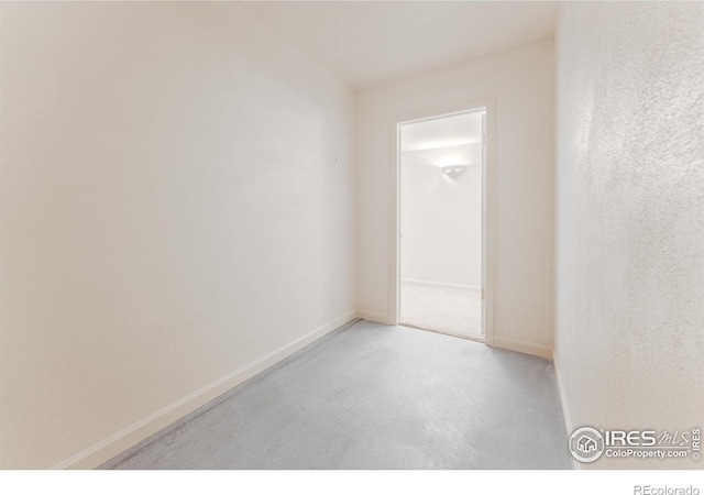 1609 Sherman Way, Longmont, CO 80501 - empty room with baseboards and concrete floors