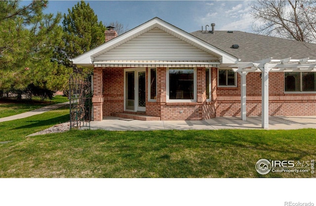 1609 Sherman Way, Longmont, CO 80501 - back of house featuring brick siding, a pergola, a yard, and a chimney