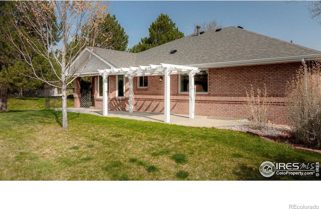 1609 Sherman Way, Longmont, CO 80501 - back of property featuring a pergola, a patio, roof with shingles, brick siding, and a lawn