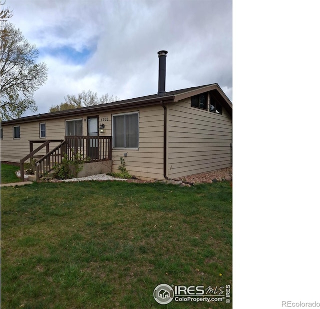4202 Coronado St, Greeley, CO 80634 - rear view of house with a yard