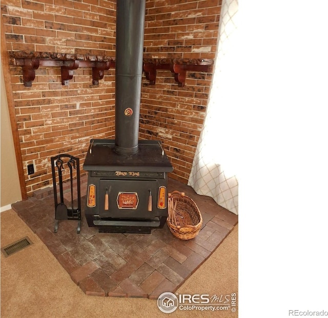 4202 Coronado St, Greeley, CO 80634 - details with carpet floors, a wood stove, and visible vents