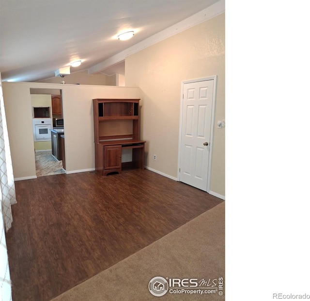 4202 Coronado St, Greeley, CO 80634 - unfurnished living room with wood finished floors, baseboards, and lofted ceiling