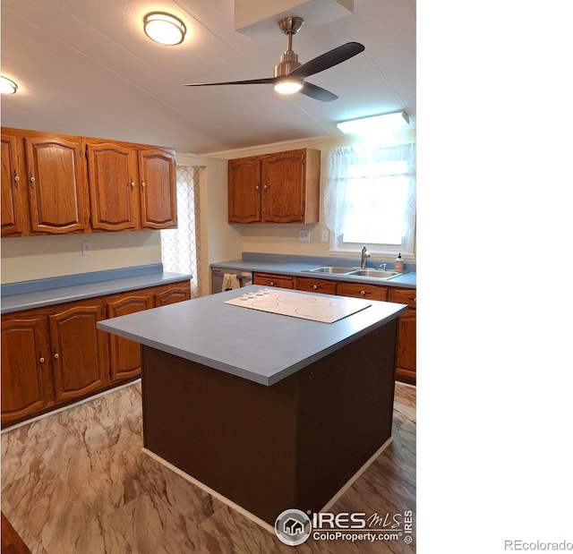 4202 Coronado St, Greeley, CO 80634 - kitchen featuring a sink, white electric cooktop, a center island, a ceiling fan, and vaulted ceiling