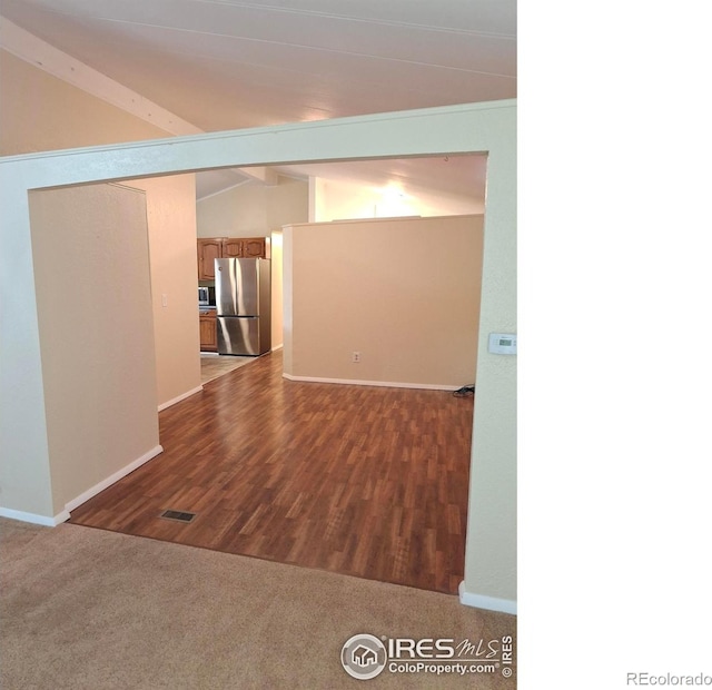 4202 Coronado St, Greeley, CO 80634 - unfurnished room featuring baseboards, visible vents, vaulted ceiling with beams, and dark wood-type flooring