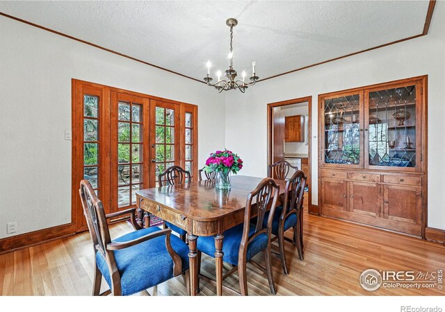 1025 5th St, Boulder, CO 80302 - dining room with a notable chandelier, a textured ceiling, french doors, baseboards, and light wood-type flooring