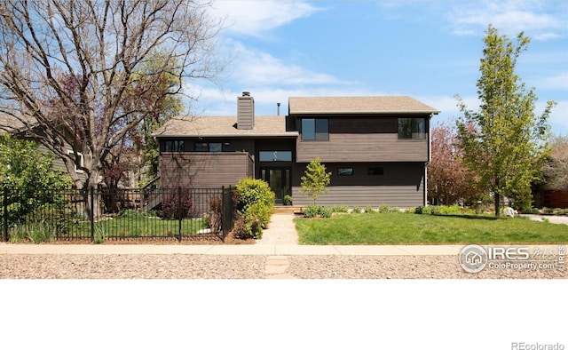 3809 Howe Ct, Boulder, CO 80301 - split level home featuring fence private yard, a front lawn, and a chimney