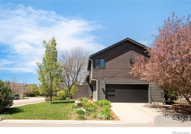 3809 Howe Ct, Boulder, CO 80301 - view of home's exterior with a lawn, a garage, and concrete driveway