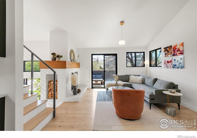 3809 Howe Ct, Boulder, CO 80301 - living area featuring stairway, baseboards, high vaulted ceiling, and wood finished floors