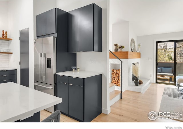 3809 Howe Ct, Boulder, CO 80301 - kitchen with open shelves, light wood finished floors, light countertops, high end refrigerator, and baseboards