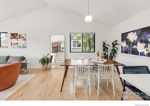 3809 Howe Ct, Boulder, CO 80301 - dining space with stairs, baseboards, wood finished floors, and high vaulted ceiling